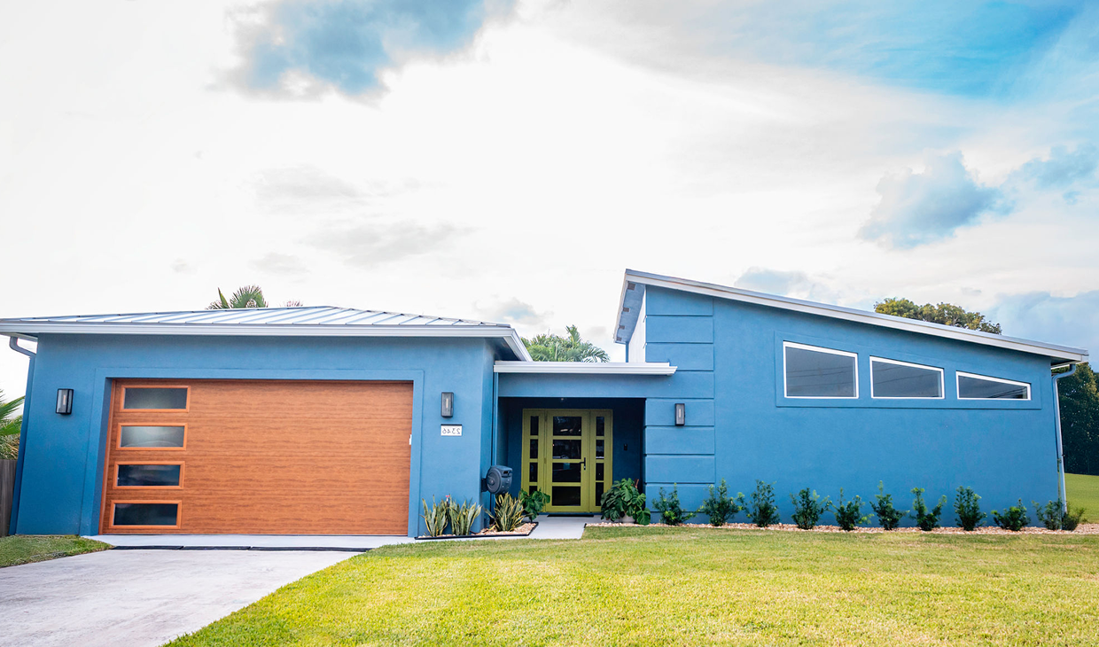 Modern blue house with wooden garage door