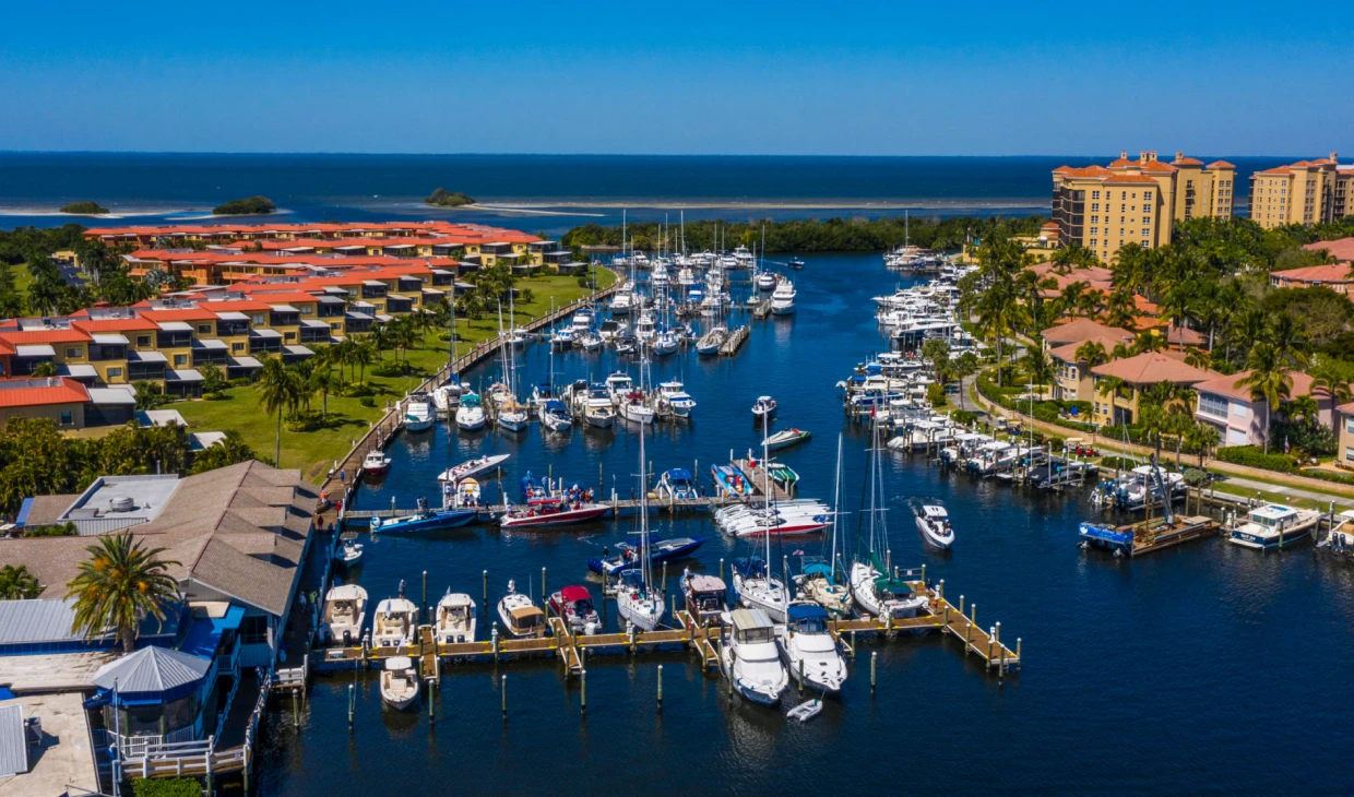 Marina with boats and waterfront buildings.