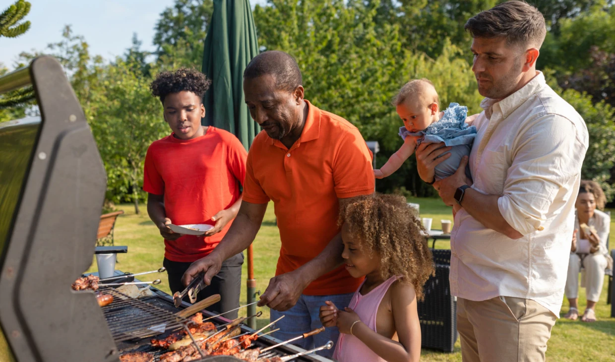 Family enjoying a barbecue in the garden.
