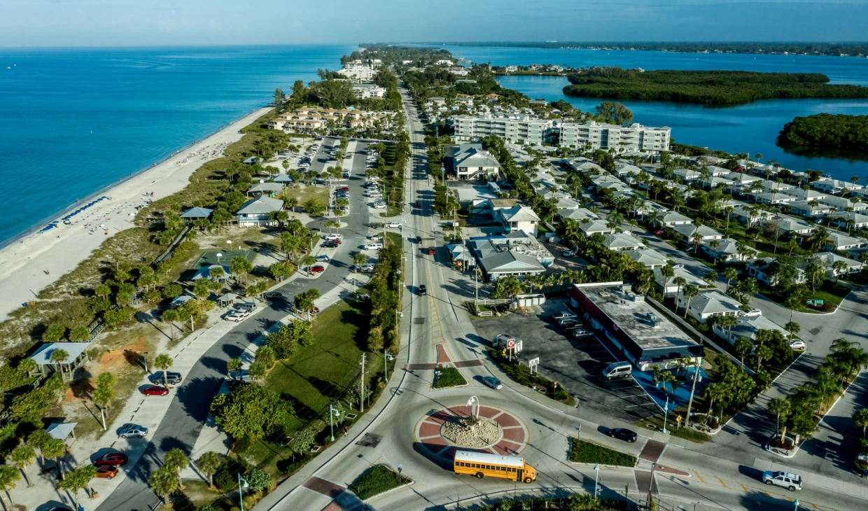 Coastal town aerial view with beach and sea.