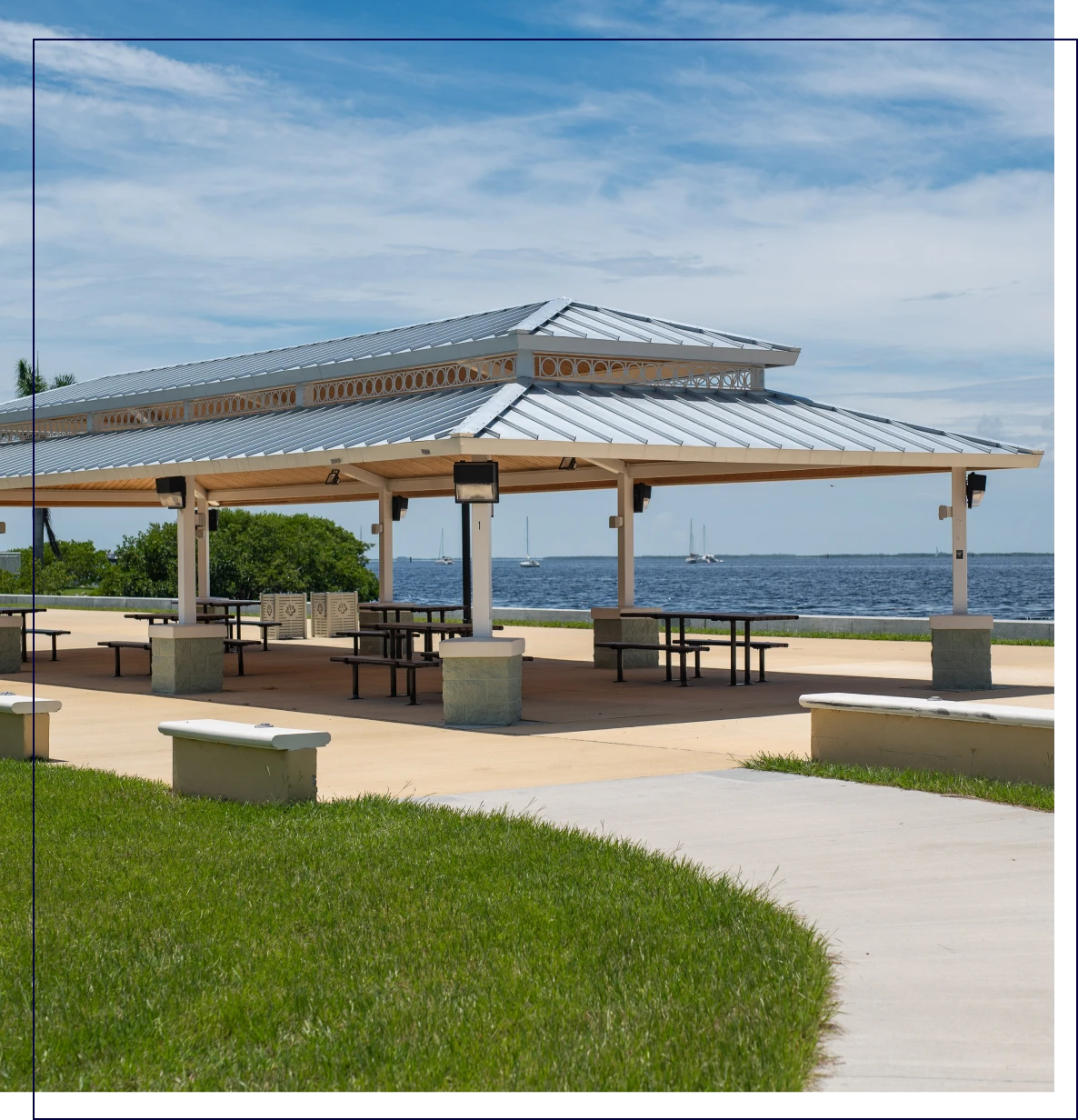 Covered picnic area by a lakeside.